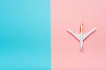 Top view of an airplane on trendy color background.  Bright summer color. Travel concept.