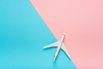 Top view of an airplane on trendy color background.  Bright summer color. Travel concept.