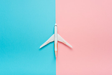 Top view of an airplane on trendy color background.  Bright summer color. Travel concept.