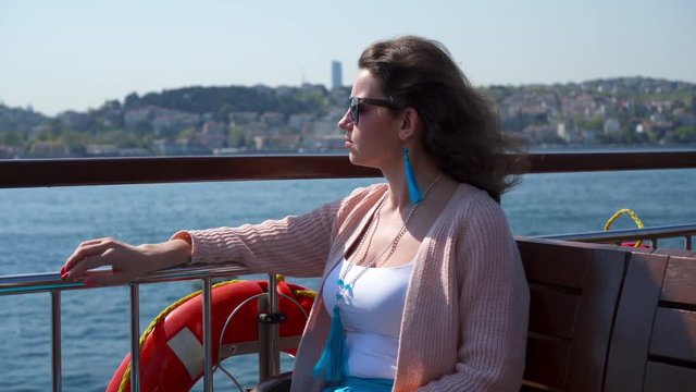 Woman in sunglasses enjoying sea panorama on excursion ship