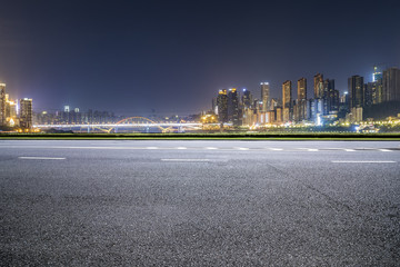 Panoramic skyline and buildings with empty road，chongqing city at night © MyCreative