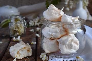 Meringues cookies. Homemade Meringue kisses drops with acacia flowers. Vintage photo. Copy space