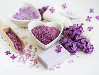 Obraz na płótnie Canvas Spa towel and massage products with lilac flowers