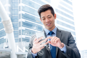 Young handsome Asian businessman  using mobile phone