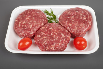 beef burgers in plastic package isolated on white background