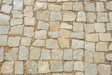 Square stone pavement cobbles, Algarve, Portugal.