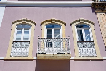 Traditional Portuguese building with pretty wrought iron balconies in the old town, Silves, Portugal.