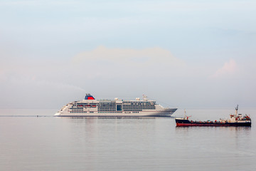 Cruise liner and cargo ship on the sea surface in the Limassol bay, Cyprus
