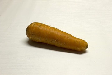 Carrot isolated on a White textured background with a dark shadow