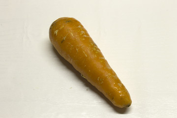 Carrot isolated on a White textured background with a dark shadow