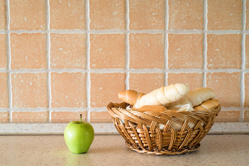 Fresh bread and apple on the table