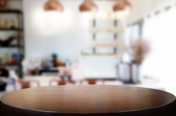 Selected focus empty brown wooden table and Coffee shop blur background with bokeh image. for your photomontage or product display