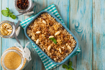 Traditional, mexican baked sweet rice, with almonds, raisins and walnuts.