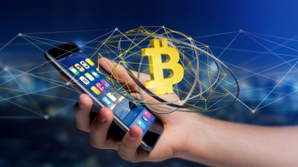 Businessman using a smartphone with a Bitcoin crypto currency sign flying around a network connection - 3d render
