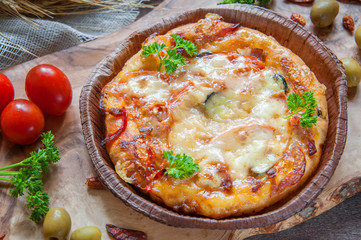 Round sausage pizza Margherita on a beautiful natural blackboard of olive . Selective focus.