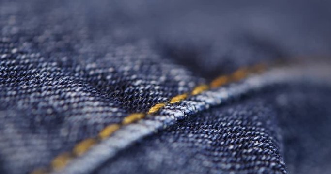 Soft blue background texture made from extreme close up macro rack focus shot of blue jeans cloth, shot with a rack focus moving from front to back and back to front.