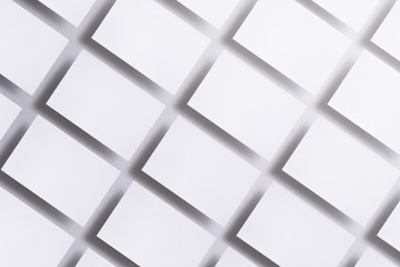 Photo of blank business cards on white. Mock-up for branding identity. For graphic designers presentations and portfolios. business cards stacks arranged in rows at white textured paper background.