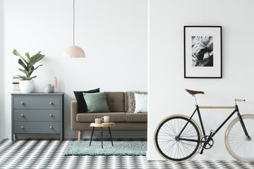 Bike and painting on the wall in a modern living room interior in the background with a chest of...