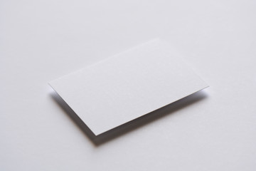 Photo of blank white business cards on white. Mock-up for branding identity. For graphic designers...