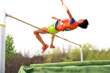 A male athlete is on the high jump