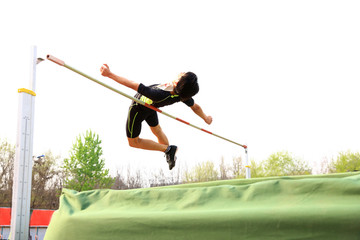 A male athlete is on the high jump