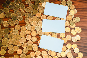 Blank business card or name card with copy space for add text name address and company logo, stack of coin on working table, financial company concept.