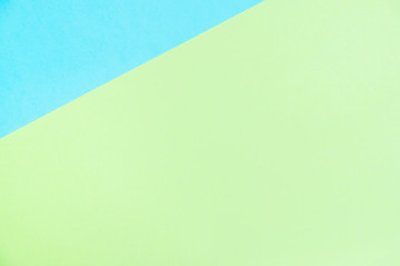 Pastel colored paper flat lay top view, background texture, blue and green.