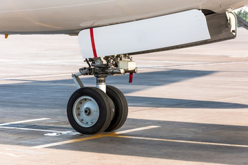 Front landing gear of passenger aircraft closeup high detailed view.
