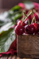 Fresh cherry with water drops on rustic wooden background. Fresh cherries background. Healthy food concept