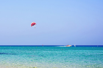 Daylight view to parasailing with people