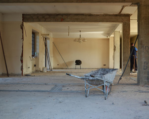 Wheelbarrow in construction site, industrial under construction empty space, architectural ground work tools