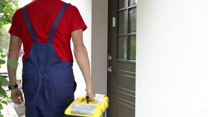 worker with tool box walk to a client house and ring the doorbell