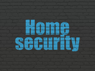 Safety concept: Painted blue text Home Security on Black Brick wall background