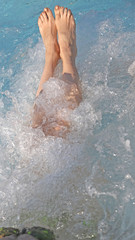 long legs and feet during the hydromassage treatment in the spa