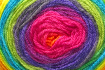 woolen threads wrapped around each other to form a target with t