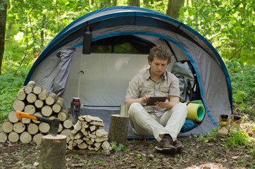 Traveller Uses A Tablet Outdoors.