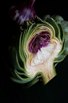 Close up of artichoke against black background