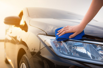 Close up portrait of woman hand cleaning a car