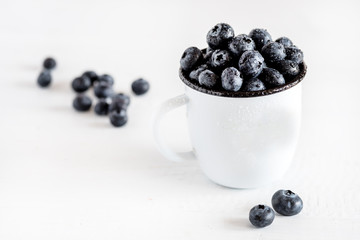 Fresh Blueberries in a White Mug White Wooden Background