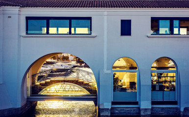 Sunset view to sun glowing through glass windows of a bar