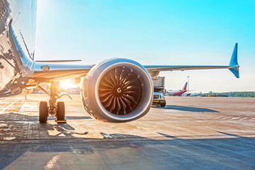 Airplane is parked at the airport before departure, the view on the wing of the chassis rack gear...