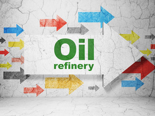 Manufacuring concept:  arrow with Oil Refinery on grunge textured concrete wall background, 3D rendering