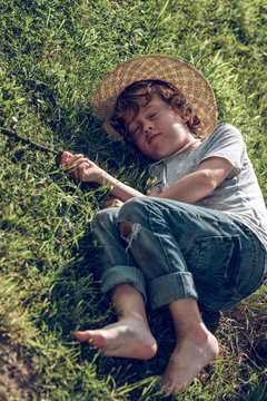 Sleepy kid on green grass