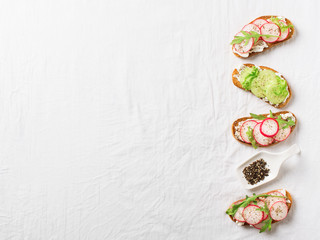 Some radish and cucumber toasts with ricotta and salad
