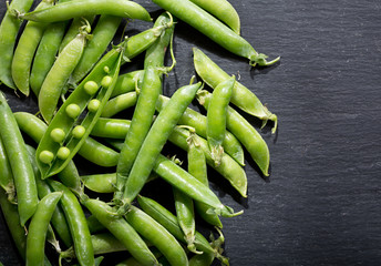 fresh green peas pod on dark background