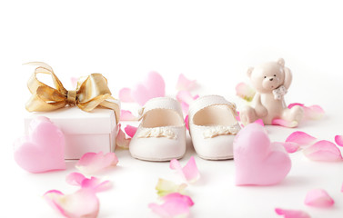 baby shoes, gift box and flowers