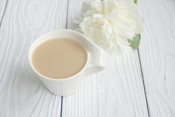 Fototapeta na wymiar White cup of coffee on a white table 