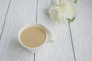 White cup of coffee on a white table  