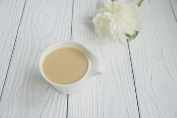 White cup of coffee on a white table  