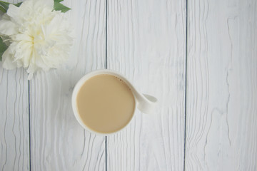 White cup of coffee on a white table  